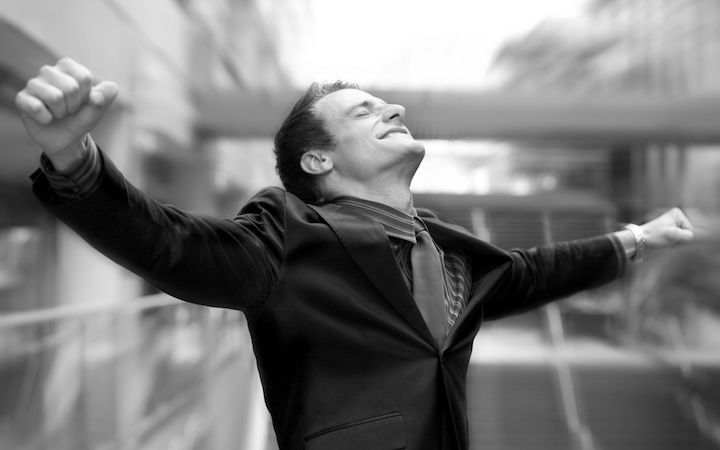 Businessman smiling with arms outstretched