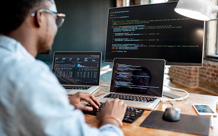 GSA client story - Cybersecurity security, man coding on computer screens