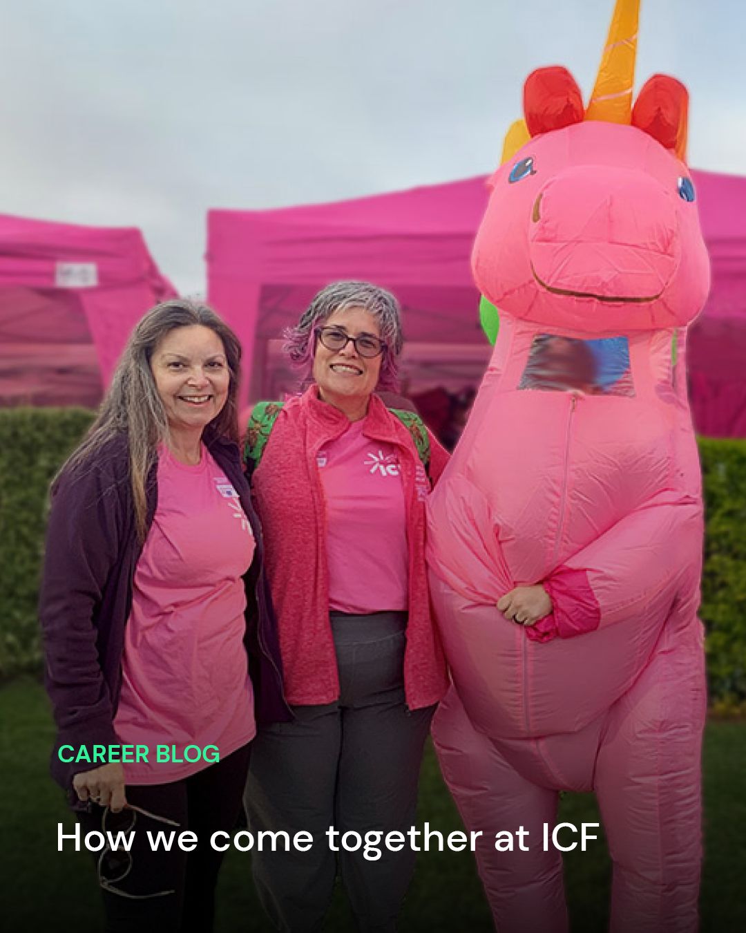 Two ICF employees wearing pink shirts standing next to a person in a pink inflatable unicorn costume, with pink tents in the background. Text overlay, "Career blog, How we come together at ICF."