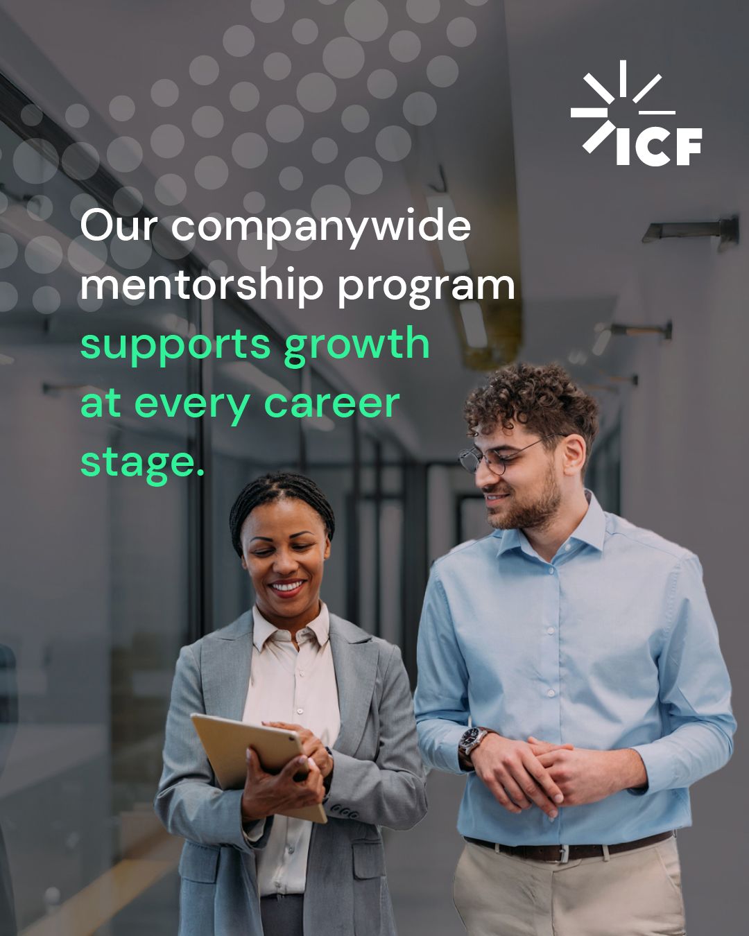Two people talking to each other in an office setting with text overlay, “Our companywide mentorship program supports growth at every career stage."