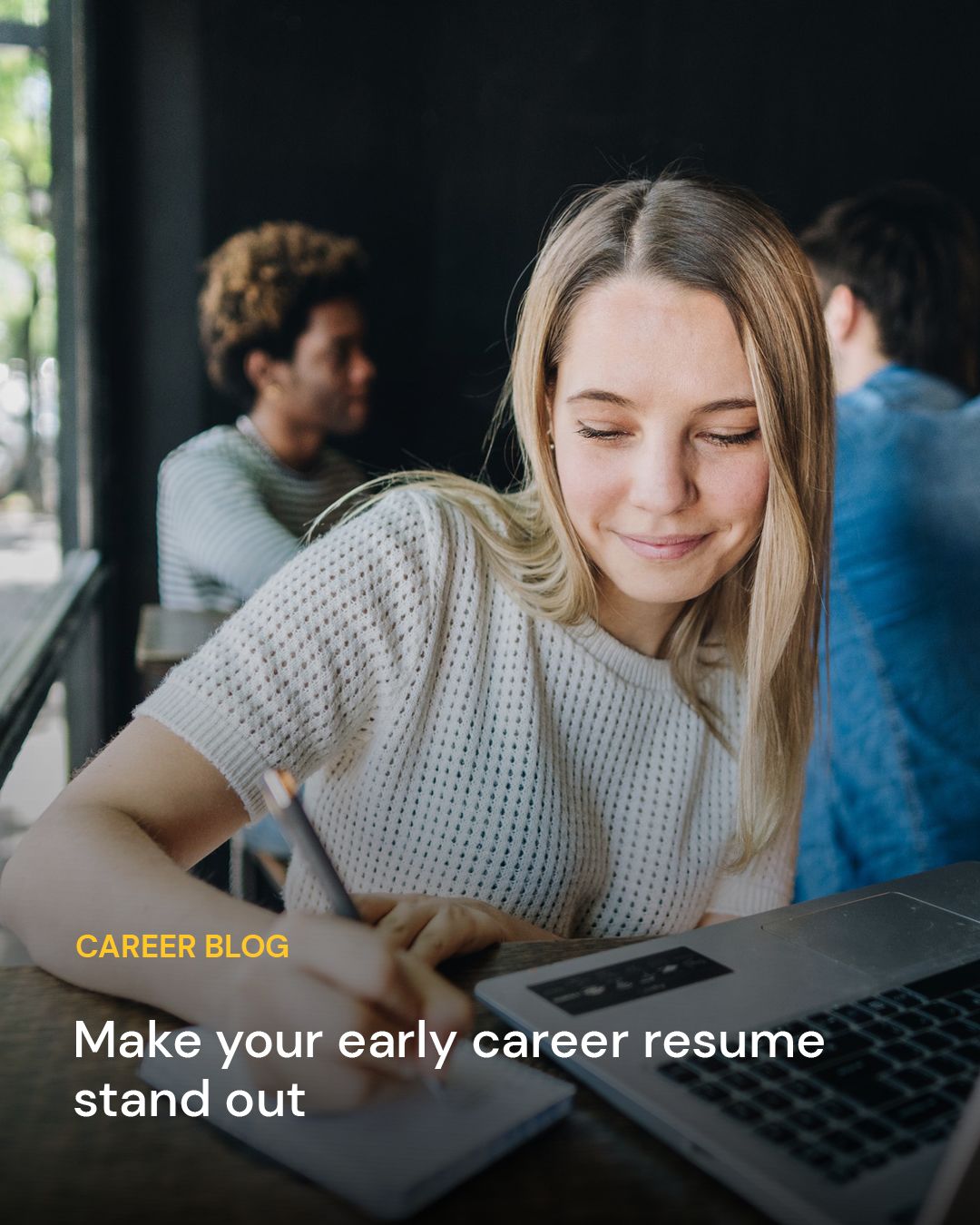 A person writing on a notepad next to a laptop. Text overlay reads: Career Blog: Make your early career resume stand out.