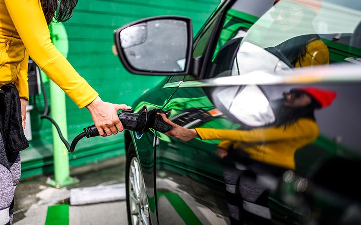 person charging electric car