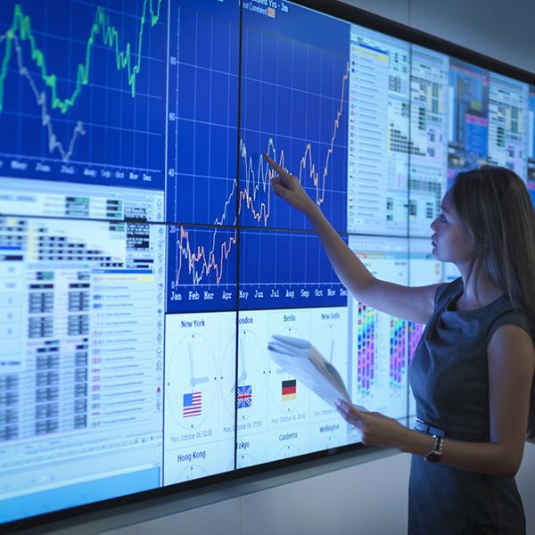 Businesswoman preparing presentation on graphical screens