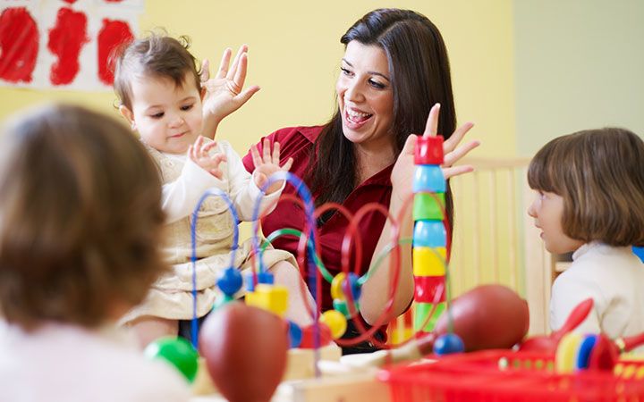 preschool teacher holding baby