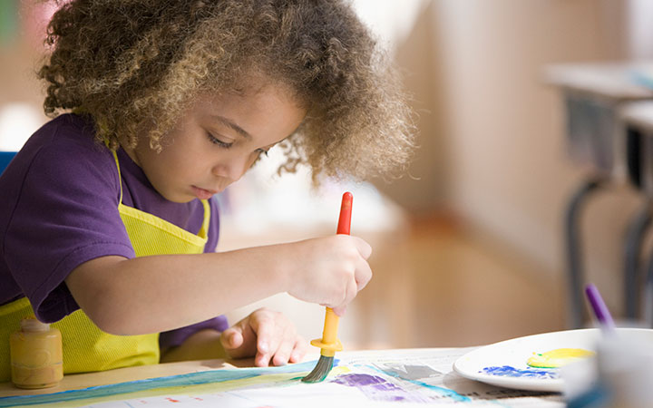 toddler painting in preschool