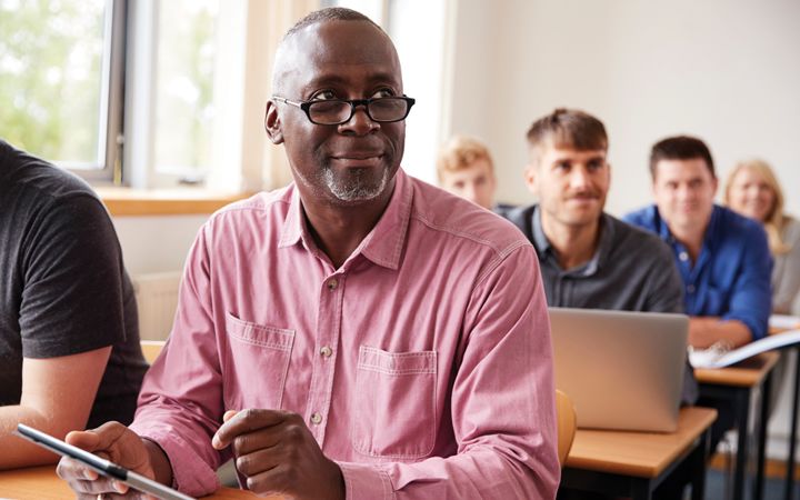 Male in education class, looking at the student