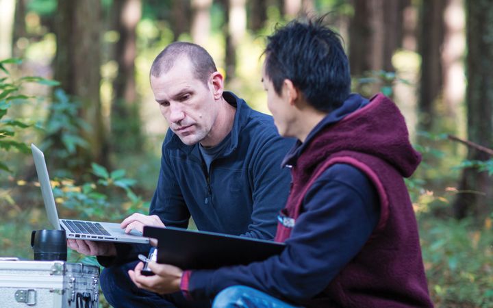 Men working on computers in the field