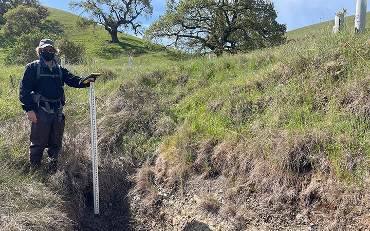 woman measuring ravine depth