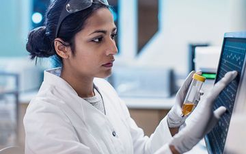 woman inspecting sample in lab