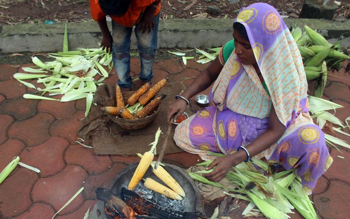 Woman cooking corn