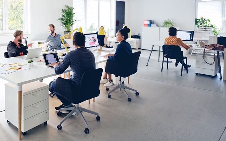 Group of coworkers discussing in a formal space 