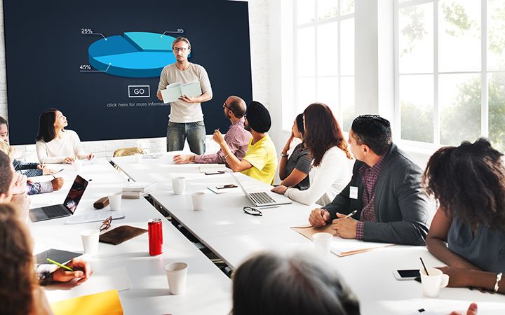 group of employees in office meeting