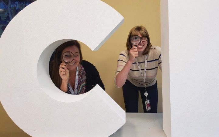 two girls holding magnifying glasses