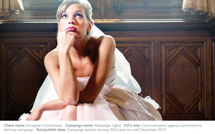 Female in a wedding dress with her arms and legs crossed, looking up