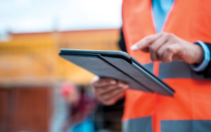man using ipad in the field