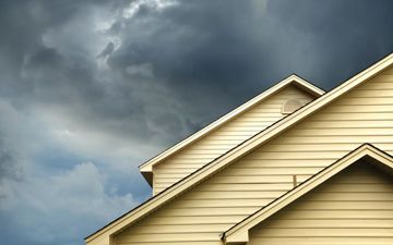 Top of a single family home with storm clouds above it - disaster preparedness solutions thumbnail