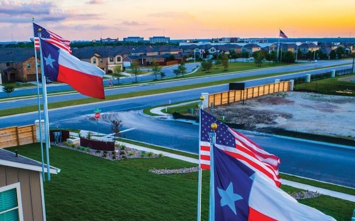 Rebuilding Texas - Texas flags flying in front of buildings