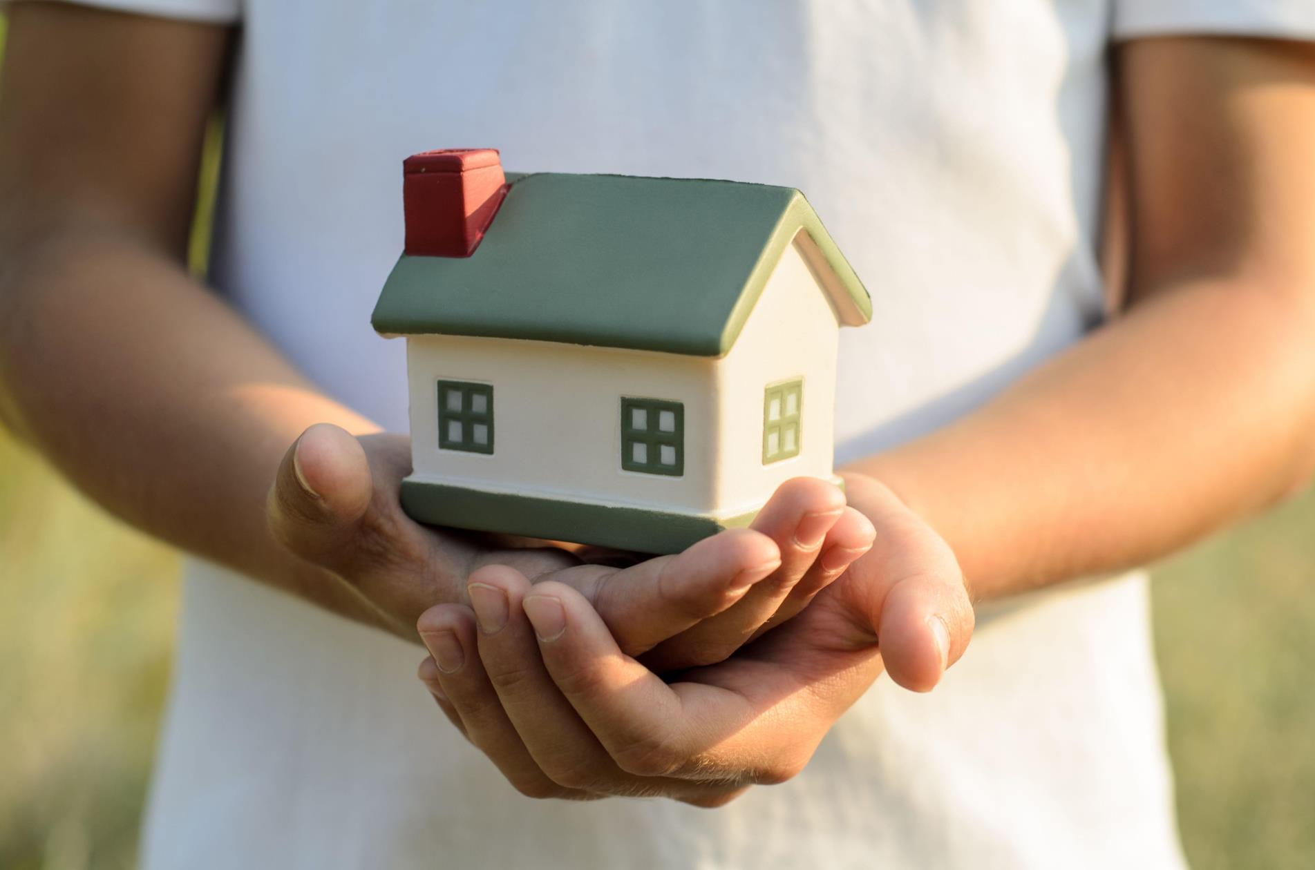 Hands holding house