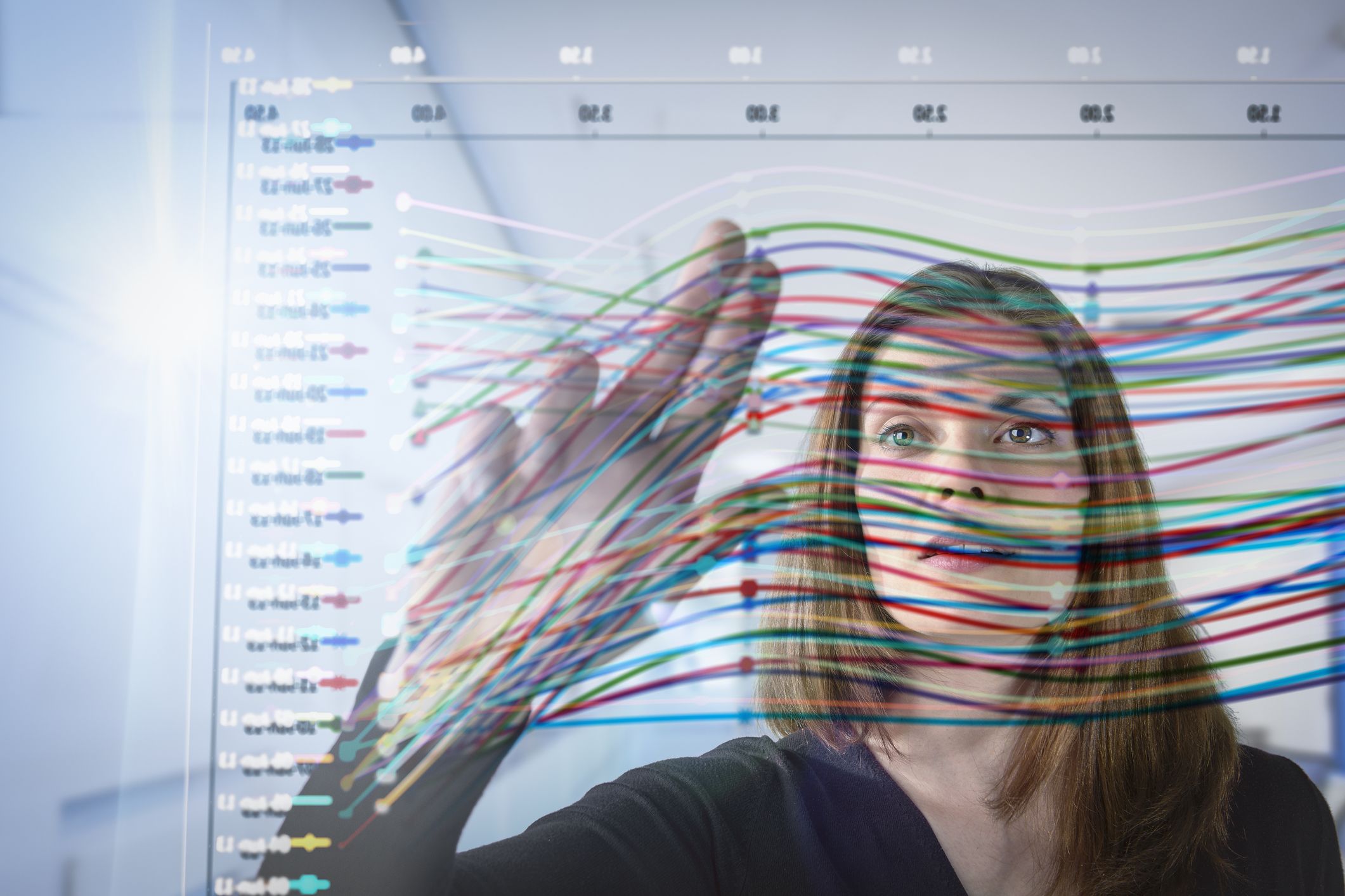 Photo of businesswoman inspecting graph on interactive display