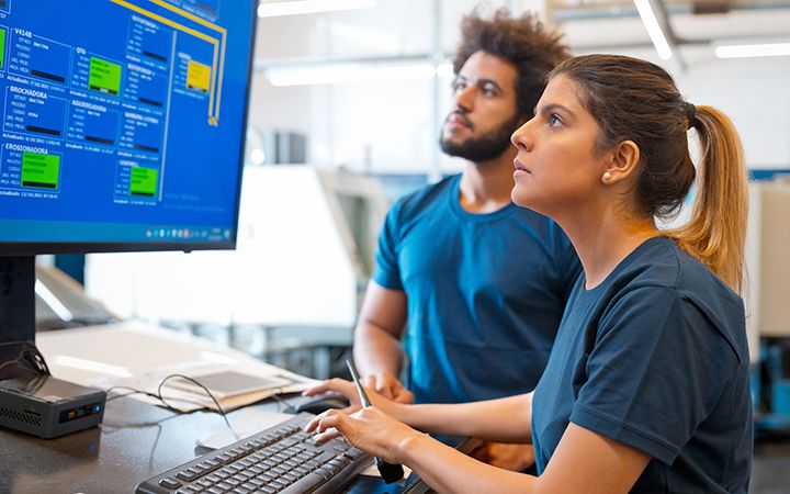 Woman analysing code on desktop screen