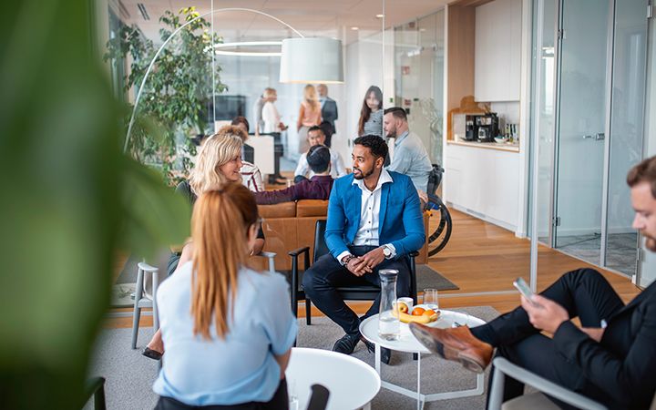 Group of people discussing in an outside lobby