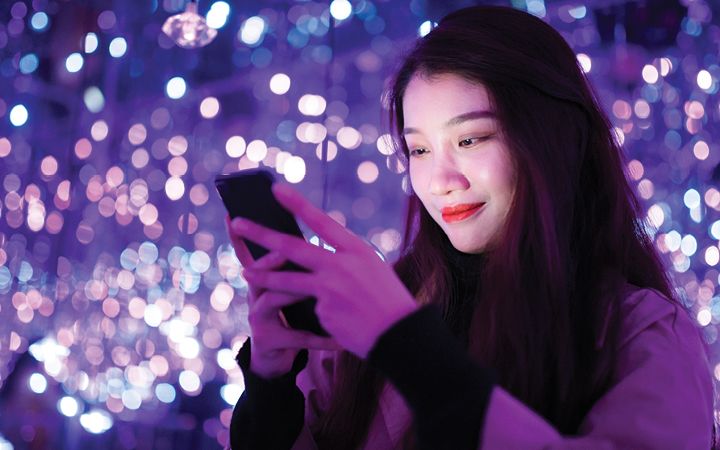 woman smiling at phone