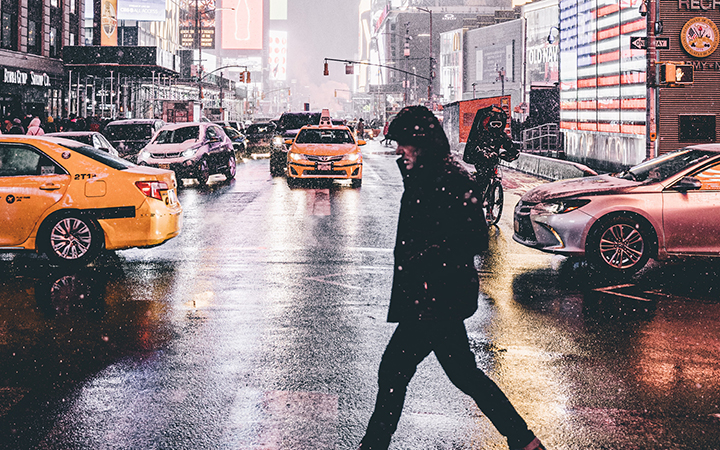 person walking across street
