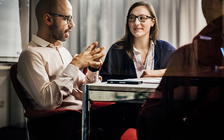 Man and woman discussing during meeting