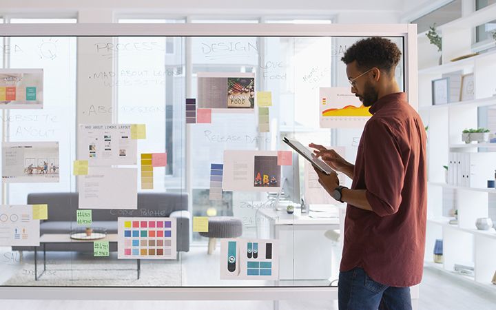 Man looking at the tablet inside a meeting room