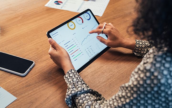 woman examining data report on tablet