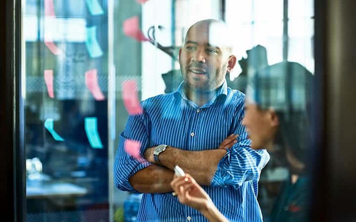 Two people planning with post-its