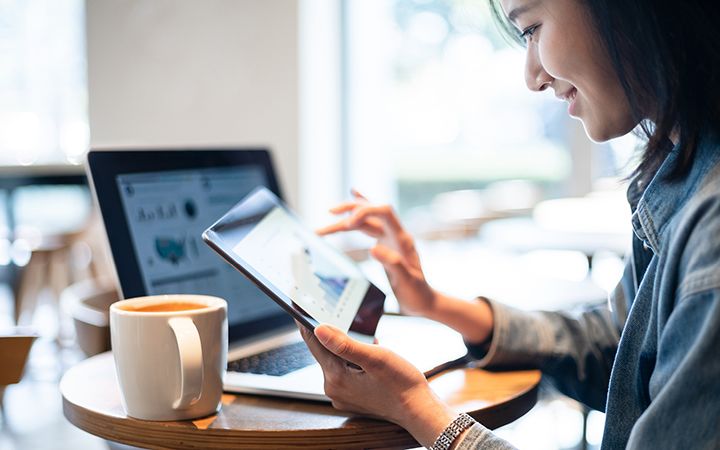 women clicking on tablet