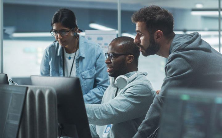 A group of coworkers discussing in a formal space