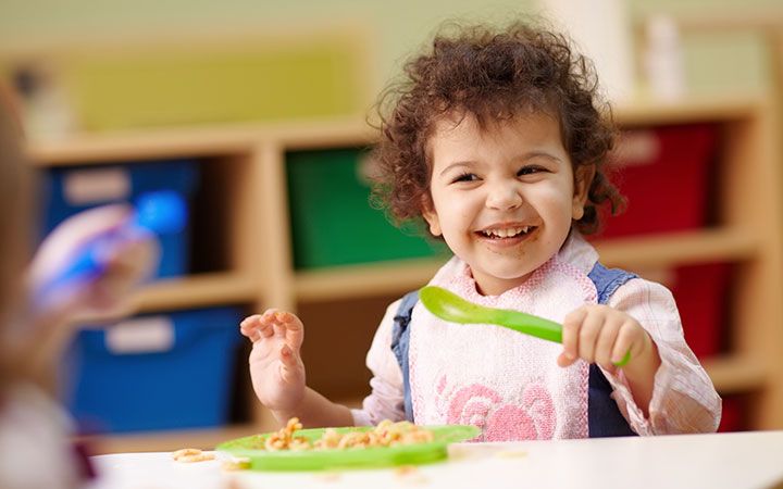 toddler eating lunch at school